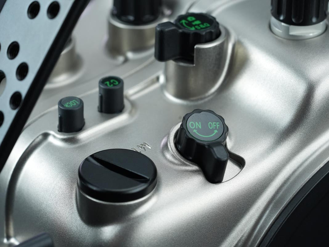Close-up of a control panel with knobs and switches on a metallic surface.
